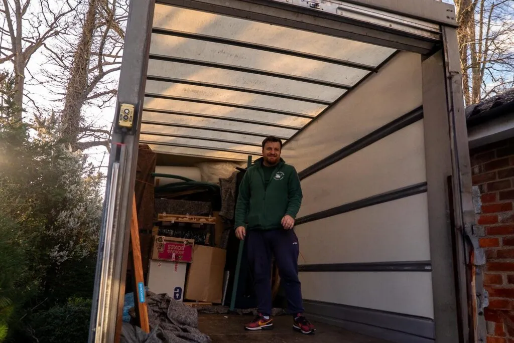 White Glove Surrey mover standing inside a loaded removals van
