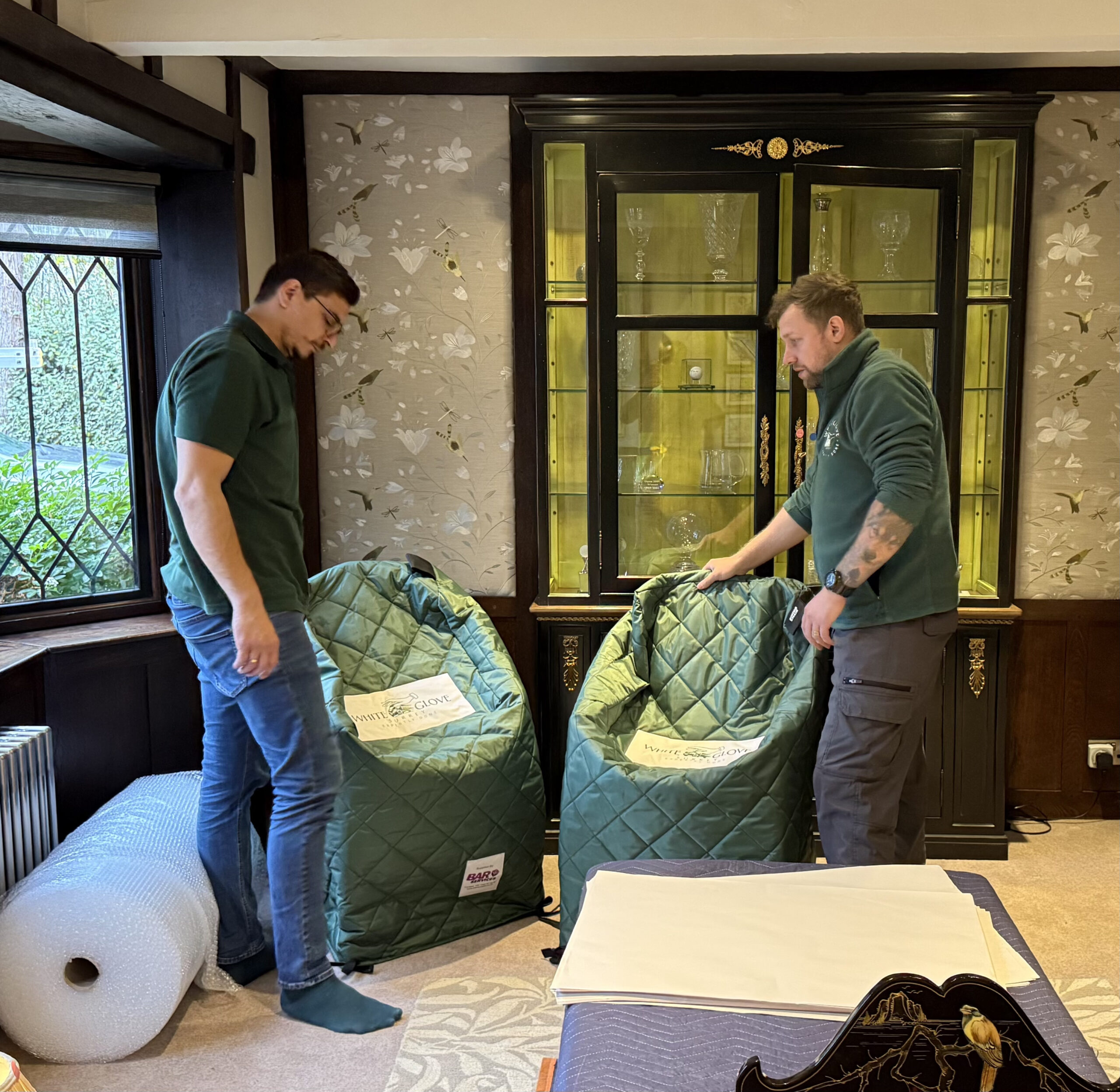 White Glove Surrey movers using padded covers to protect furniture
