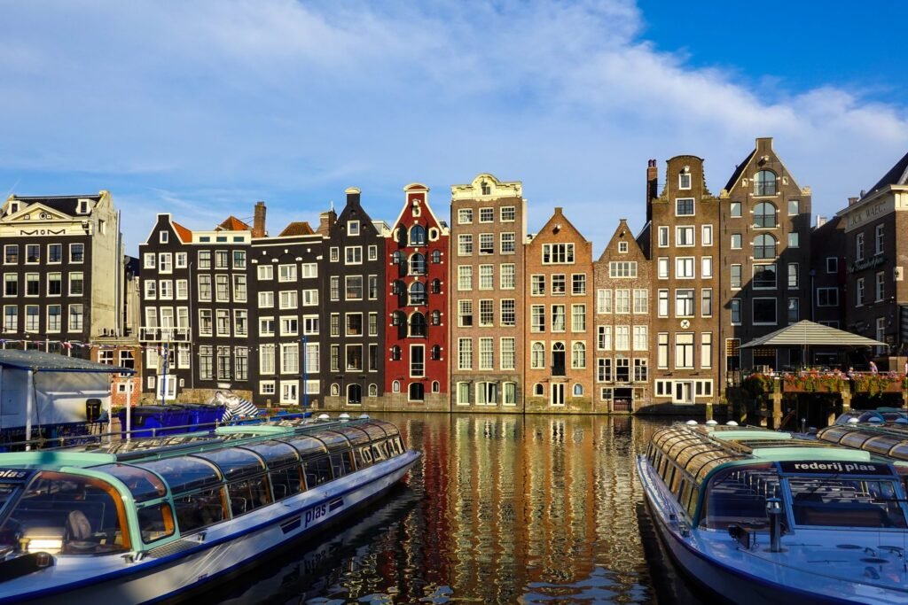 Canal houses and boats in Amsterdam — removals to the Netherlands from Surrey and London