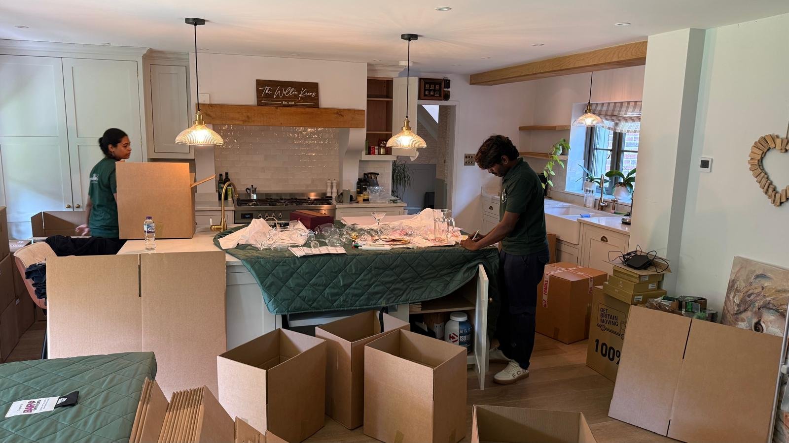 White Glove Removals team carefully packing a family kitchen during a home move in Surrey