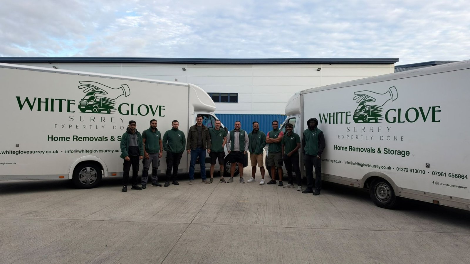 The White Glove Surrey removals team in front of two branded lorries